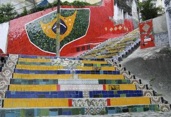 Escadaria Selarón no Rio de Janeiro - RJ com mosaico da Bandeira do Brasil ao fundo.